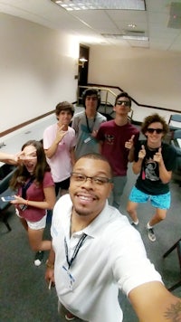 a group of people posing for a selfie in an office